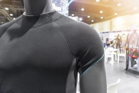 A diving or scuba diving suit is worn on a mannequin in a shop, with a pers.. Stock Photos