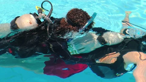 Diving in the pool. Top view of the instructor in scuba gear with an oxygen Stock Footage 163486191