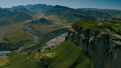 Diving into riverbed of Colca Canyon valley past giant rock cliff, Peru Stock Footage 115369283