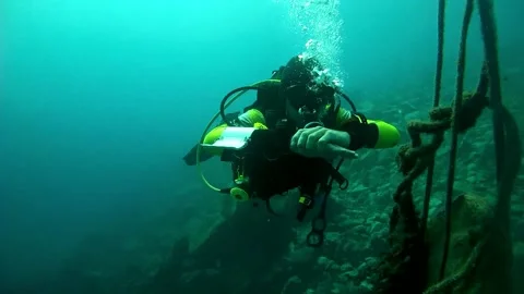 Diving sign- divemaster  shows sing  SAFETY STOP ON FIVE METERS Stock Footage 158799383