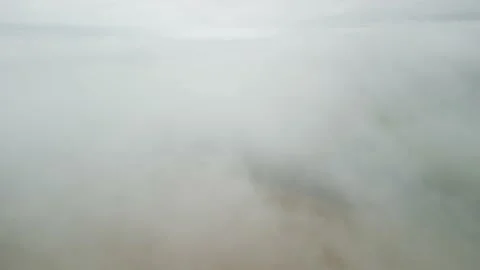 Diving through dense fog to reveal wheat field and road. Stock Footage 234636803