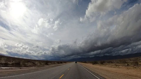 Diving through stormy desert road, Drivers point of view forward process Stock Footage 103107308