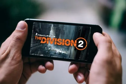 The division 2 Game from Tom Clancy logo title screen is displayed on smartphone Stock Photos
