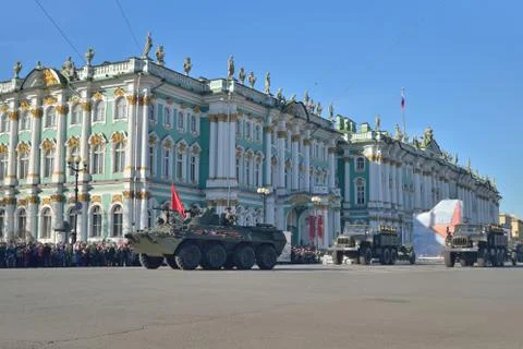 A division of infantry on the APC with a red flag and trucks on Stock Photos