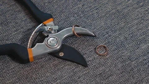 Divorce and breakup shown through rings and scissors Stock Footage 332045798
