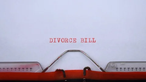Divorce bill - phrase printed on an old typewriter in red letters, close up. Stock Footage 129535954