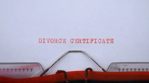 Divorce certificate - phrase printed on an old typewriter in red letters Video stock 129535929