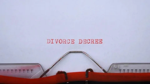Divorce decree - phrase printed on an old typewriter in red letters, close up. 動画素材 129535964