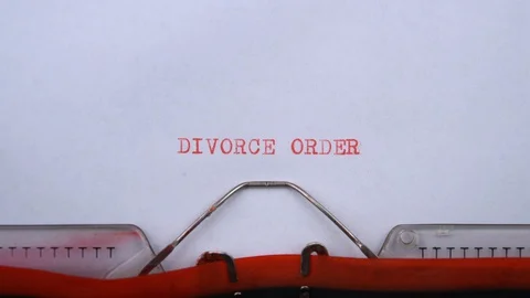 Divorce order - phrase printed on an old typewriter in red letters, close up. Stock Footage 129536026