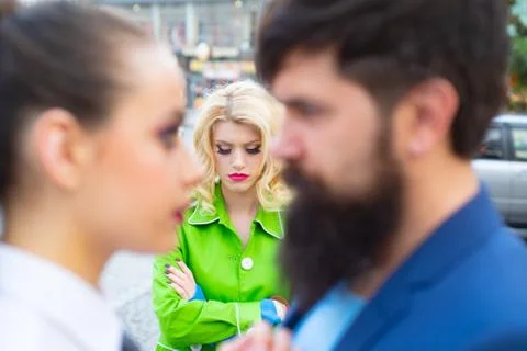 Divorce reason. Infidelity. Disloyal man walking with his girlfriend and looking Stock Photos