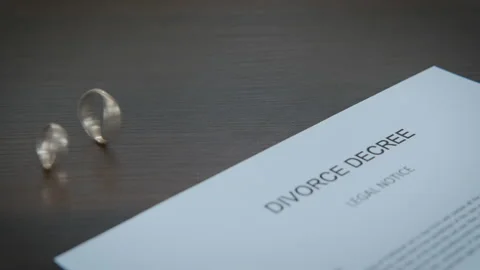 Divorce rings on papers. Stock Footage 137873661