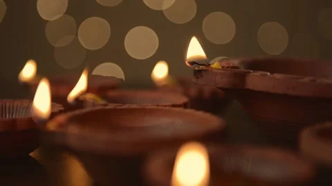 Diwali Celebration Diya flame tilt transition from bokeh shallow depth -HD Stock Footage