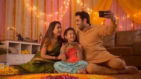 Diwali festival - Indian lovable family taking selfie or self photograph Stock Footage