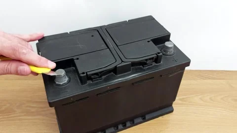 DIY Battery Hack: Safely Access Terminals with a Utility Knife Stock Footage 316373676