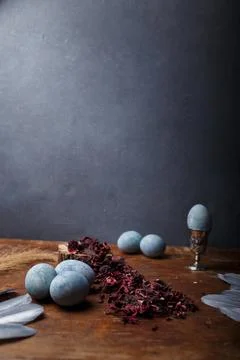 DIY blue painted easter eggs, one egg in egg cup, dry Hibiscus tea Stock Photos