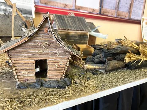 DIY childrens craft model of a rustic wooden house made from sticks and straw Stock Photos