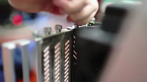 DIY computer builder tightening screw to hold GPU in place Stock-Footage 158753505