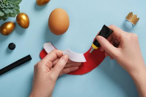 DIY Easter Egg King. Step-by-step instructions. Step 6. Glue the white part of t Stock Photos
