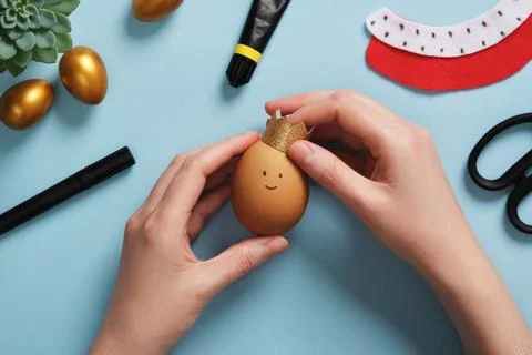 DIY Easter Egg King. Step-by-step instructions. Step 9: Attach the crown to t Stock Photos