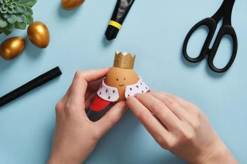 DIY Easter Egg King. Step-by-step instructions. Step 10. Attach the royal robes  Stock Photos