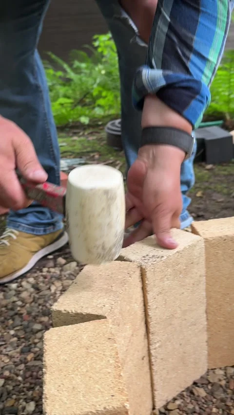 DIY Fire Pit Construction With Fire Bricks and Rubber Mallet 库存影片 342002011