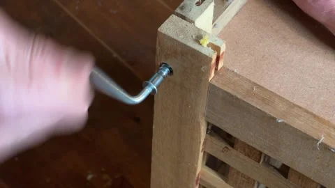DIY Flatpack table being screwed up tight Stock Footage 328230631