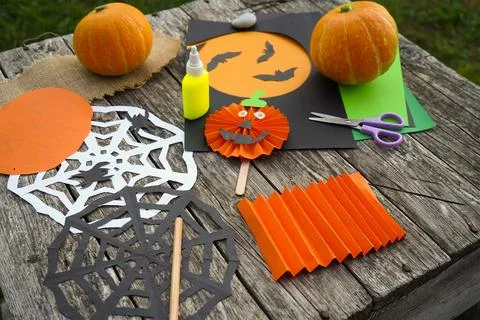 DIY Halloween decorations layout featuring accordion folded orange paper, s.. Stock Photos