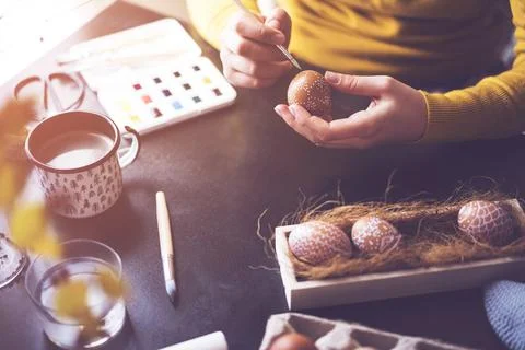 DIY hand painted easter eggs. Unrecognizable person hand painting easter eggs Stock Photos