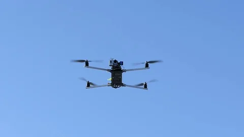 DIY handmade quadcopter in blue sky. Slow motion. Stock Footage 70945082