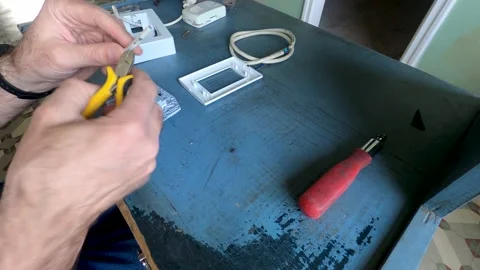 DIY Hands assembling a box with a double electrical outlet in a plastic box. Stock Footage 161110099