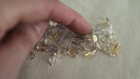 DIY jewellery making process. Closeup of female hands selecting beads Stock Footage 318482476