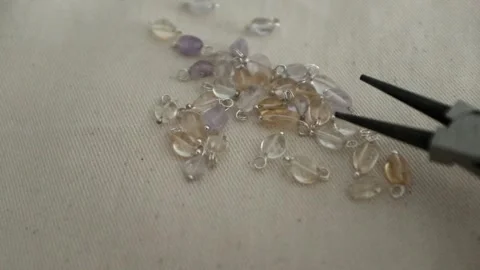 DIY jewellery making process. Closeup of female hands selecting beads Stock Footage 318482487