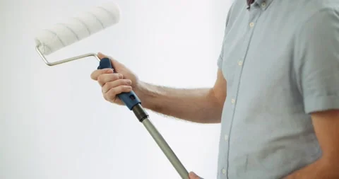 DIY Man uses an extension pole on a roller Stock Footage 155795941