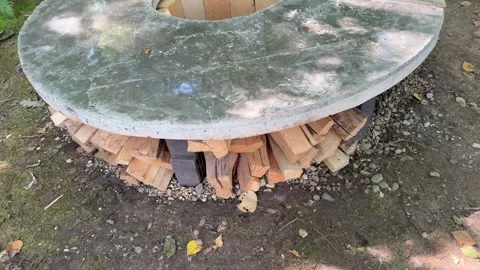 DIY Round Outdoor Fire Pit Under Construction in Woodland Backyard Video stock 342630751