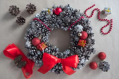 DIY. Step 4: top view of a Christmas wreath of fir cones, decorative toys and Stock Photos