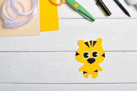 DIY tiger. Step by step. Handmade. Step 3. Glue the eyes and nose to the body Stock Photos