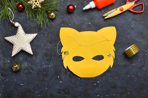DIY tiger. Step by step. Handmade. Step 8. Attach the elastic band to the mas Stock Photos