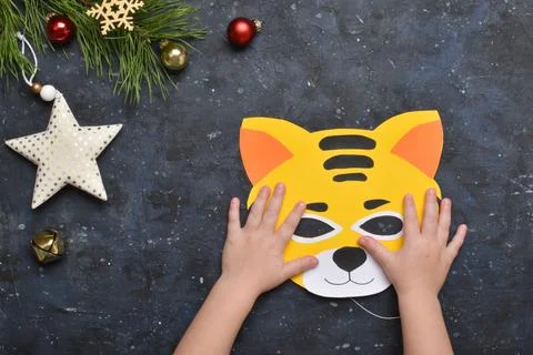 DIY tiger. Step by step. Handmade. Step 10. A ready-made tiger mask in the ha Stock Photos