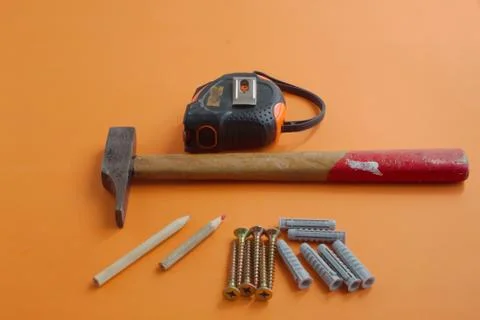 DIY tool set consisting of screws, dowels, hammer and tape measure Stock Photos