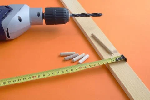 DIY tool set consisting of screws, dowels, drill machine and tape measure Stock Photos