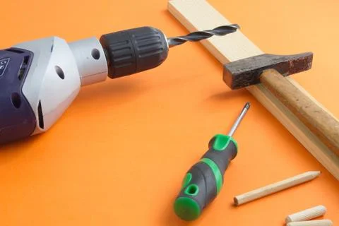 DIY tool set consisting of screws, dowels, drill machine and screwdriver Stock Photos