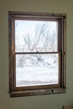 DIY window insert install in old house with wintery snow and trees in view Stock Photos