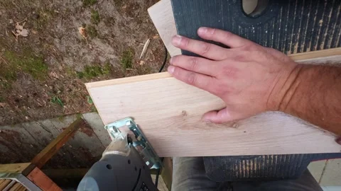 DIY woodworking: cutting laminate board with jigsaw for home renovation. Stock Footage 341079730