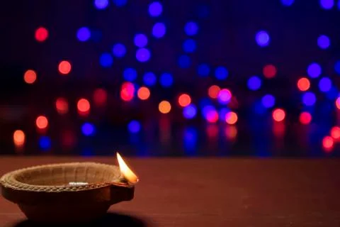 Diya lamps lit with bokeh background during diwali celebration Stock Photos