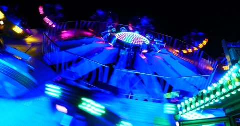 Dizzy feeling on seeing a rotating colorful carousel at night, medium shot Stock Footage 111573273