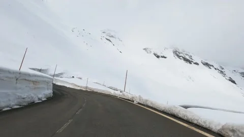 Dizzying Time-lapse of driving over a wet asphalt road in the high Alps Stock Footage 204797183
