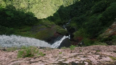 A dizzying view down the 500 foot waterfall in Mauritius from above Видео 342238769