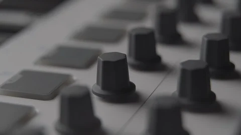 DJ adjusting audio effect knobs on MIDI keyboard while making music Stock Footage 108001323