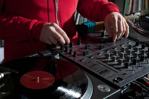A DJ adjusting knobs on a sounder mixer, detail of hands Stock Photos