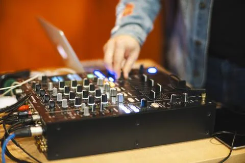 A DJ adjusts controls Stock Photos